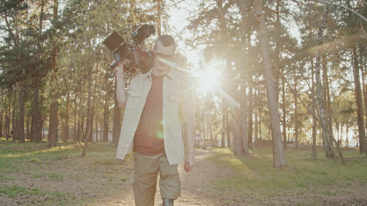 Cameraman With Prosthetic Leg Walking Along Forest Trail