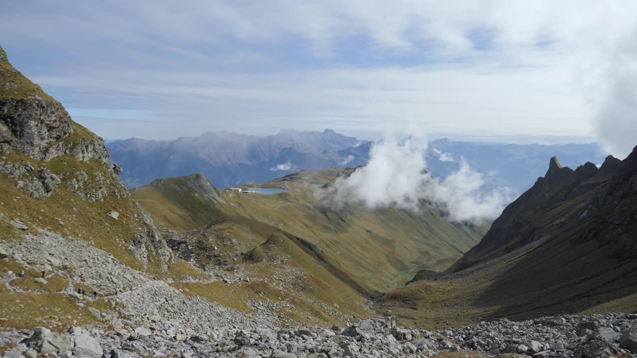 Pizol mountain path with moving clouds in sunny summer, static shot