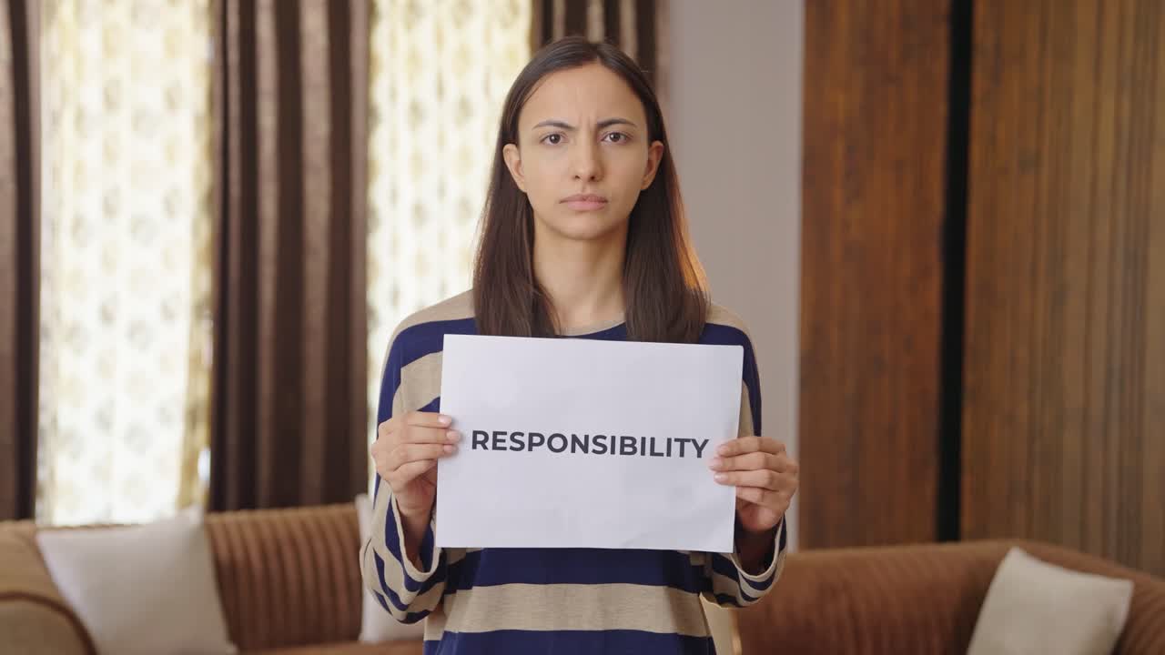 Indian woman holding RESPONSIBILITY banner