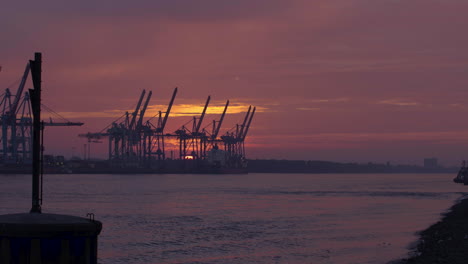 timelapse of a sunset at the port of hamburg: many ships and boats on the elbe river