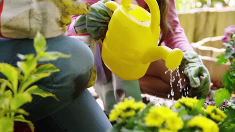 Couple-watering-flower-in-garden