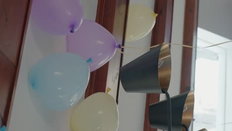 pastel balloons with hydrogen touching celling. vertical video