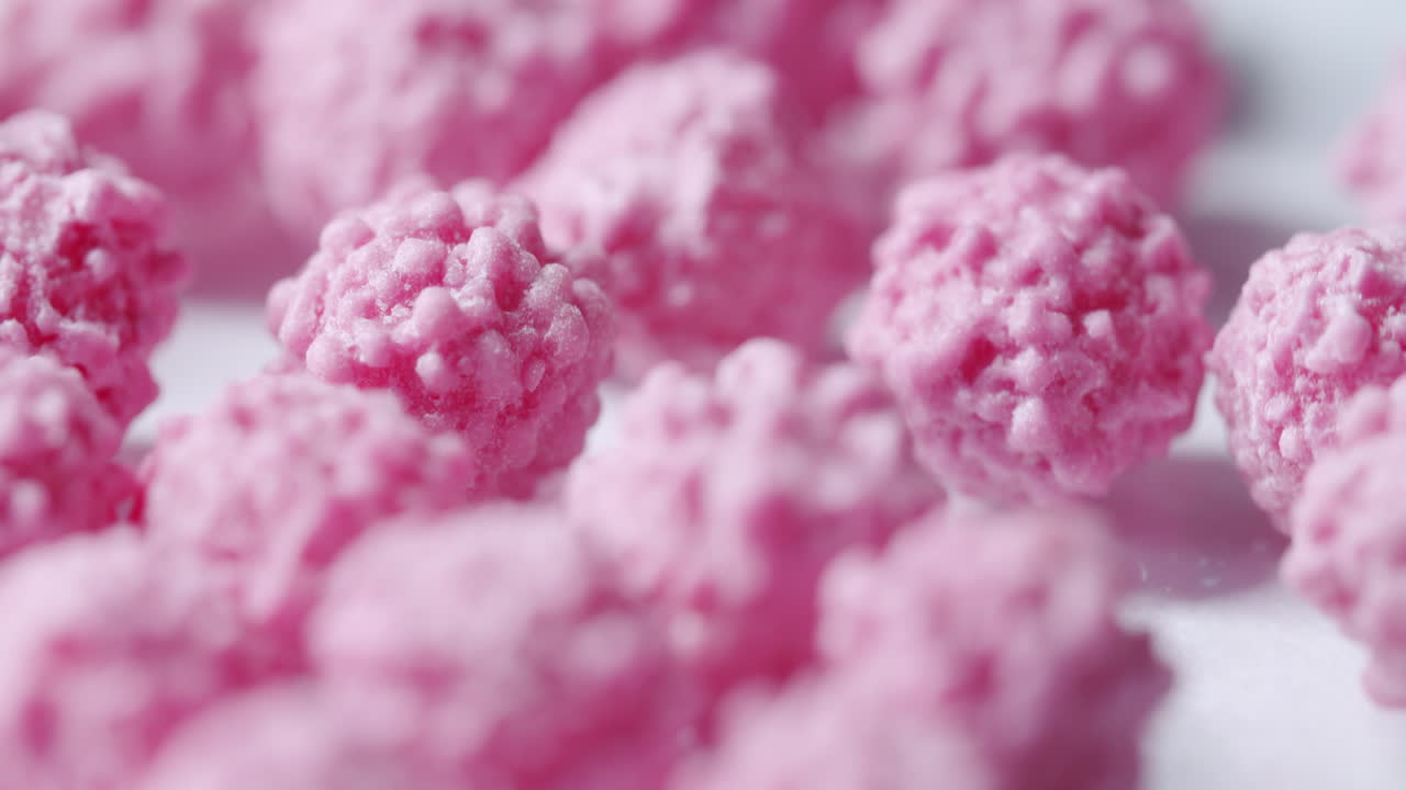 Pink particles spinning on a turntable with endless white background