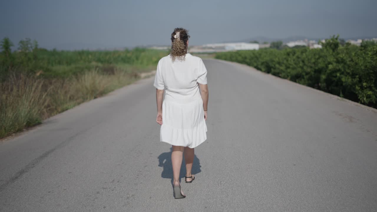 Woman Walking Down a Country Road