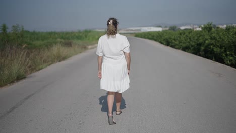 woman walking down a country road