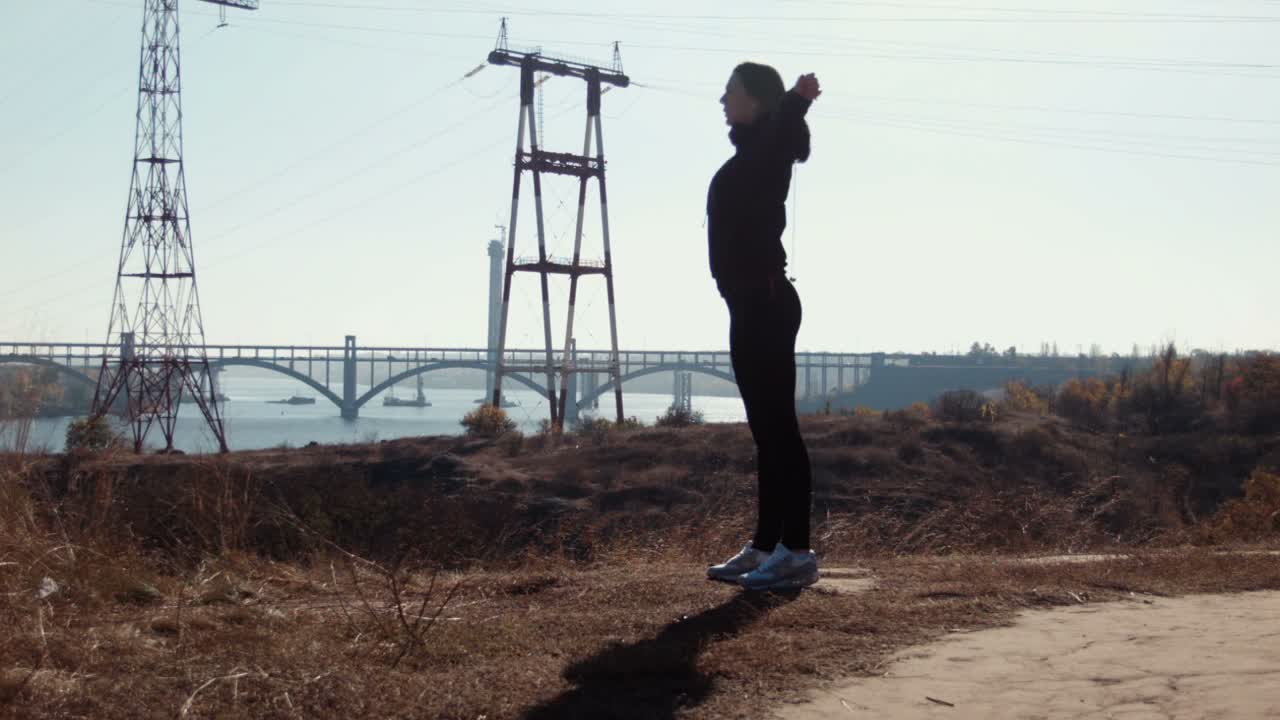 Woman Stretching Outdoors by a River