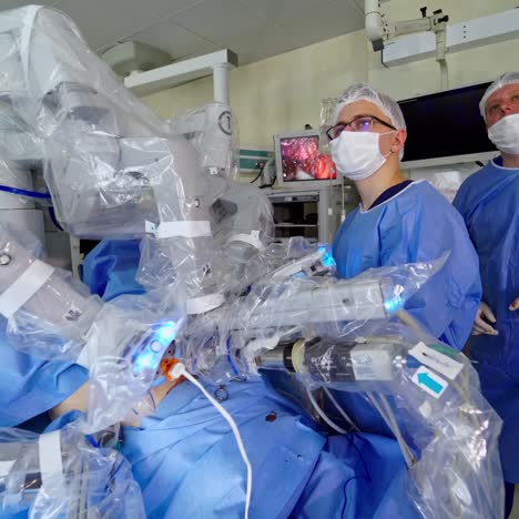 surgeons during removal surgery. medical robot da vinci surgery technology machine