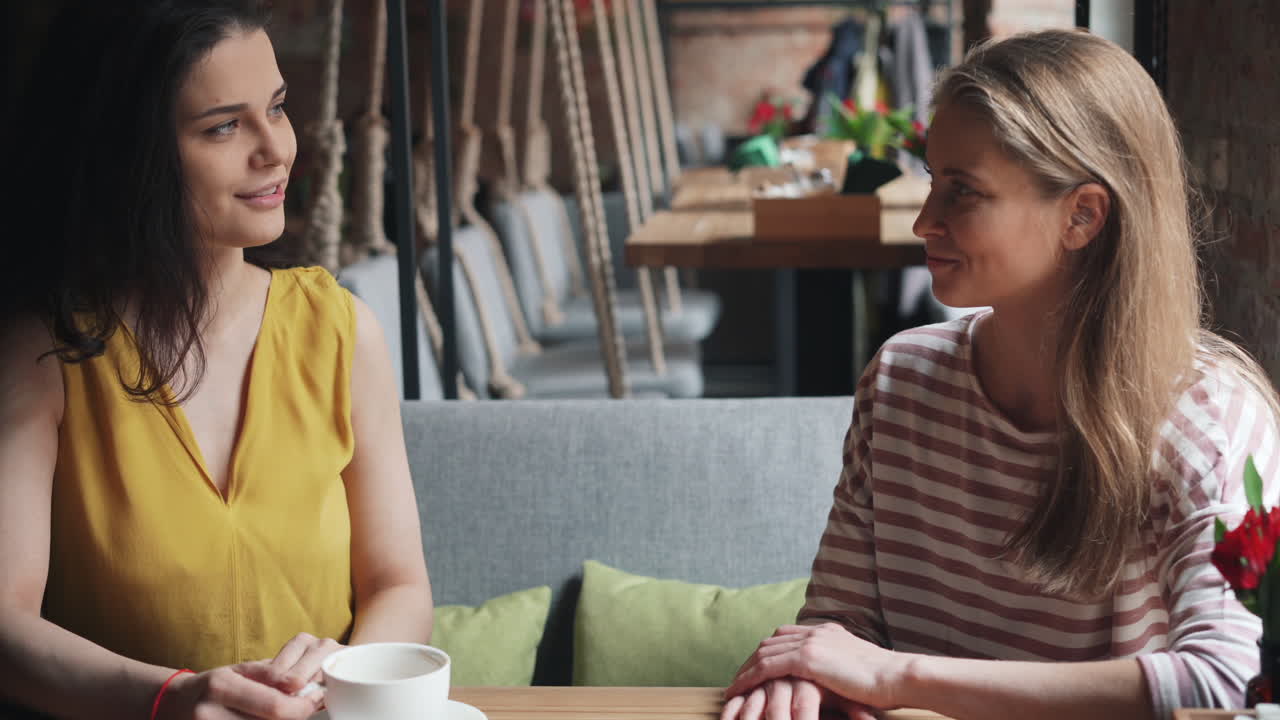 Two women friends having conversation in a cafe