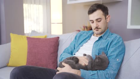 the man caresses the cat. cat and man.