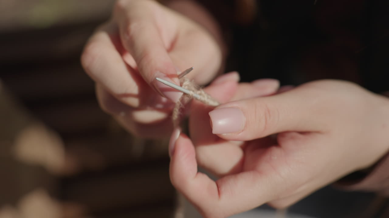 Mujer cosiendo al aire libre bajo la luz del sol, agricultor asiático cosiendo meticulosamente al aire libre con luz brillante, un agricultor asiático realizando cuidadosamente un trabajo de costura detallado a plena luz del día al aire libre