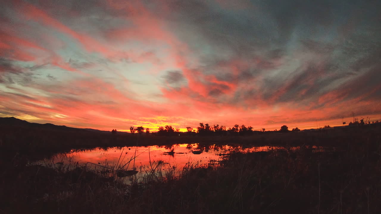 Sunset over a calm lake at night