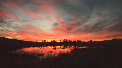 sunset over a calm lake at night