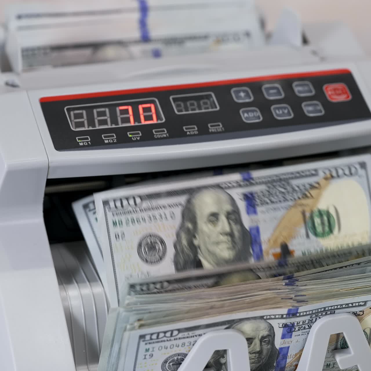 Money counting equipment for paper money calculation. Automatic mechanism for bank financial operations. Currency exchange of one hundred usd. Closeup currency counting machine counting dollar bills