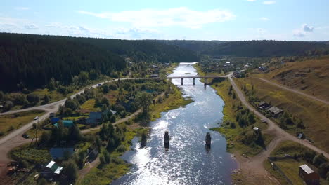 aerial view of a river valley with a bridge and village