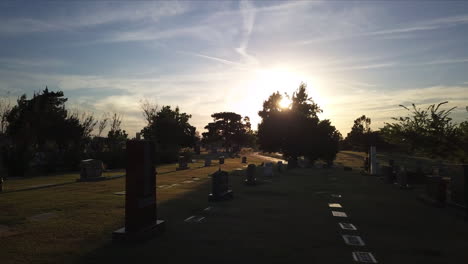 backwards dolly shot showing multiple graves in a cemetery