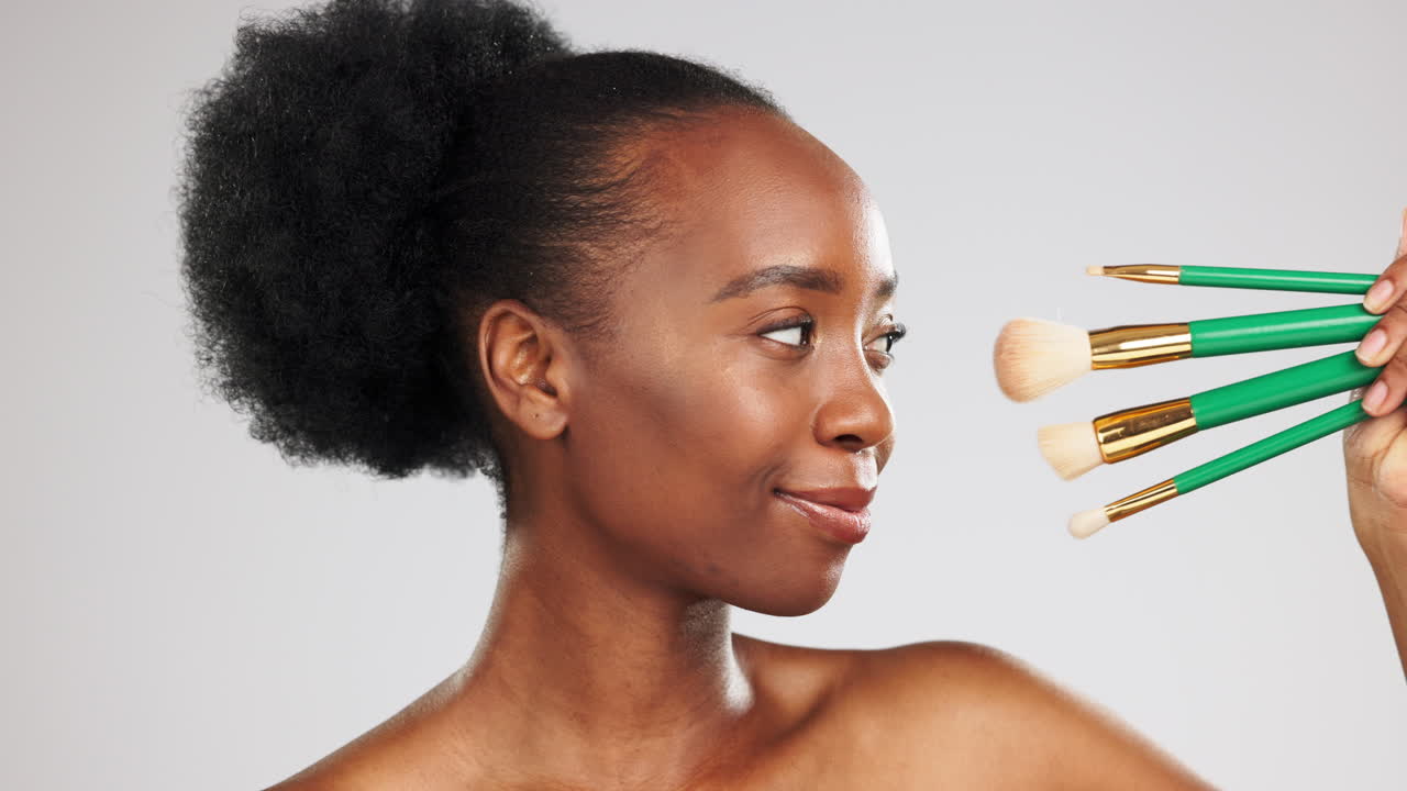 Face, makeup and happy black woman with brushes