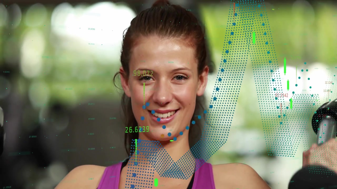 Female gym user gripping and pressing handles in gym, animated charts overlaying press metrics
