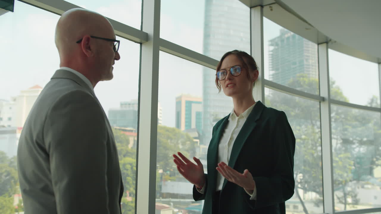 Female Manager Shaking Hands of Male Investor at Office