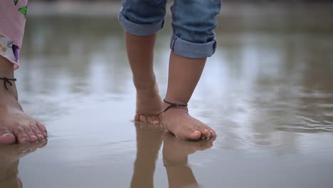 little baby learns to walk wearing jeans