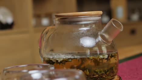 glass teapot with green tea