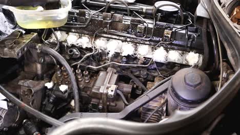 Mechanical-Guy-Wearing-Gloves-Cleaning-Upper-Part-Of-Diesel-Car-Engine-Year-1997