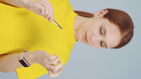 Vertical-video-of-Woman-caring-for-her-nails.