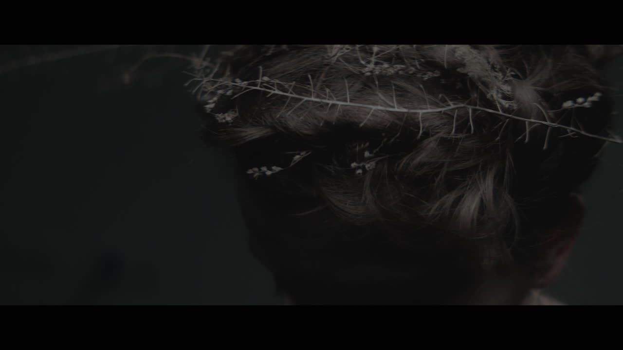 A woman dressed as mother nature shows her hair