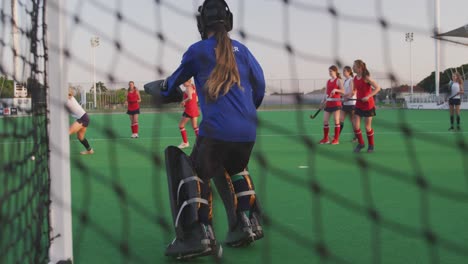 Female-hockey-players-playing-on-the-field