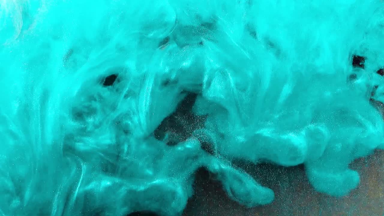 Abstract forms. Shooting on a black background. Mixing of paints