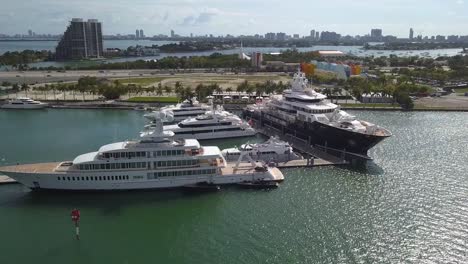 aerial view around large, luxury yachts, in sunny miami, usa - circling, drone shot