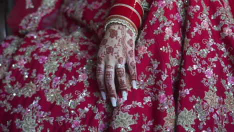 indian bride with hands tattooed with henna on wedding day