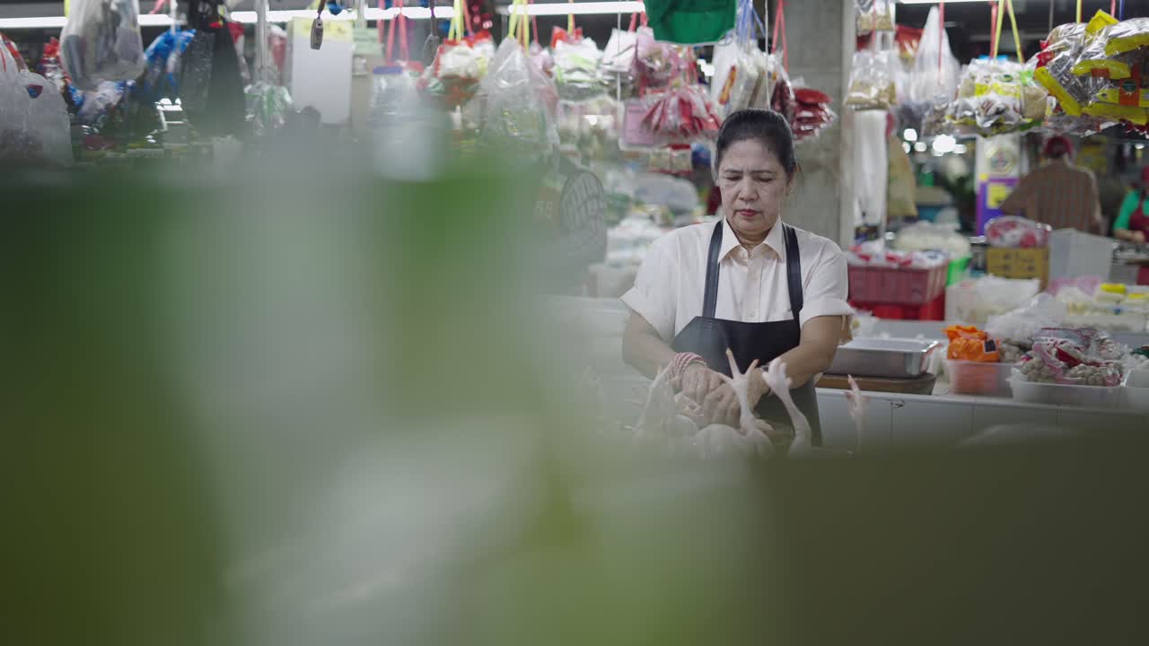 Woman Butchering Chicken at a Market
