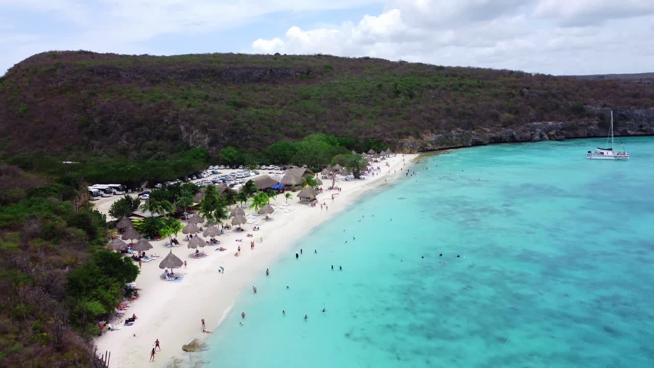 Establishing Aerial of Overcast Beach with Greenery and Parking Lot