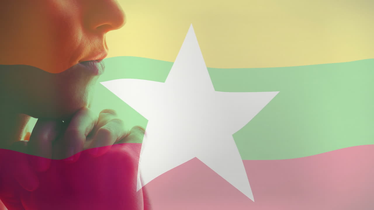 Myanmar flag colors and white star overlaying profile of person in animation