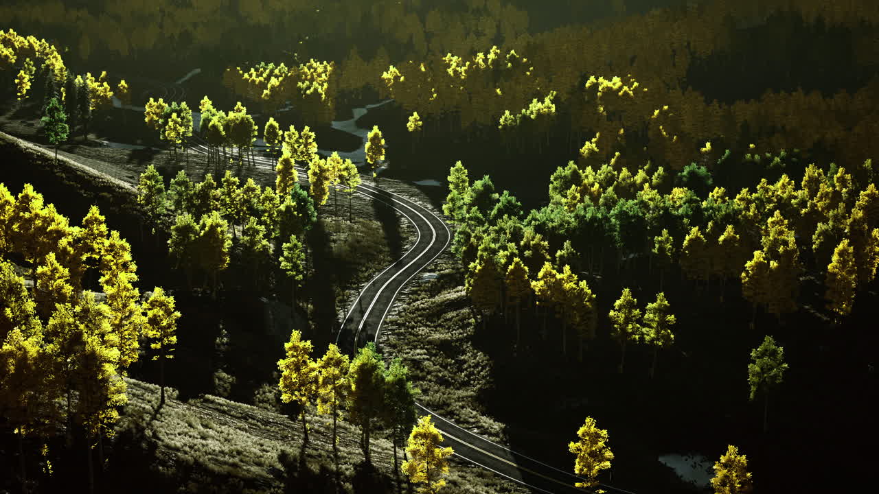 Scenic view of winding tracks through vibrant fall foliage in mountains
