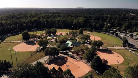 aerial drone shot of 7 field baseball complex in a public park in suburbs of atlanta shot in 4k