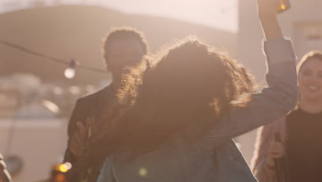 young woman dancing group of diverse friends hanging out together enjoying rooftop party at sunset drinking alcohol having fun on weekend celebration