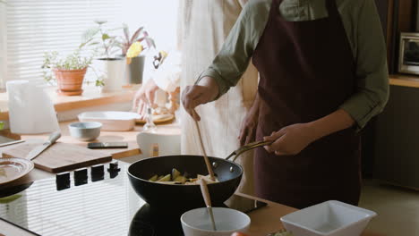 father and son cooking together in the kitchen