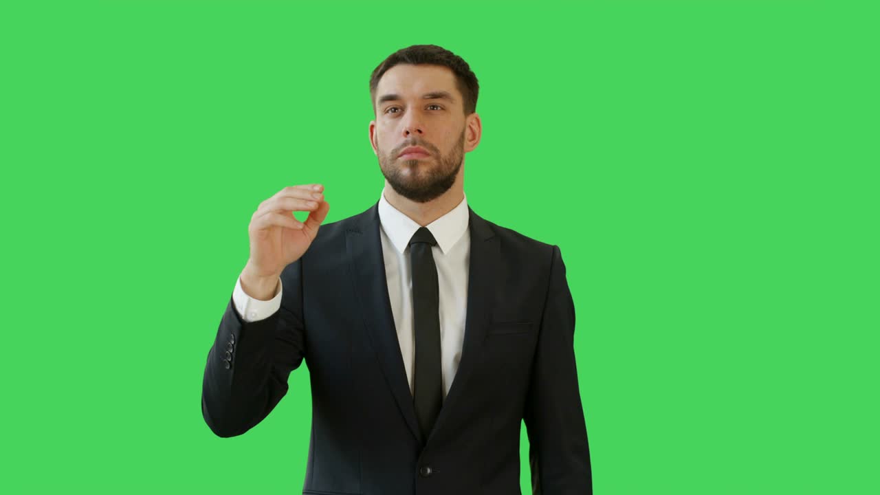 Medium Shot of a Businessman Making Swiping and Touching Gestures while Standing on a Green Screen Background.