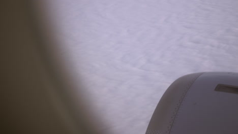 Plane-flying-over-the-white-clouds