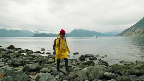 woman hiking on rocks by a lake