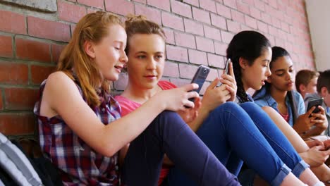 Group-of-school-friends-using-mobile-phone-4k