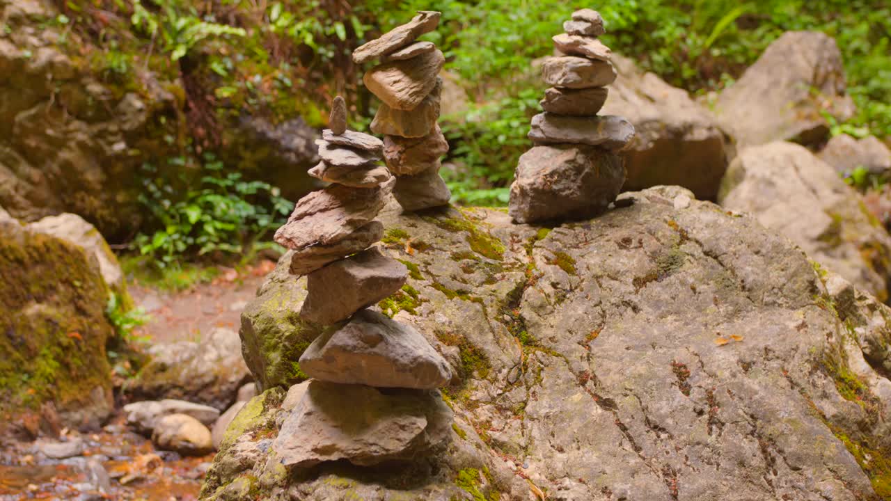 Static shot of a balanced pile of rocks in a natural outdoor setting
