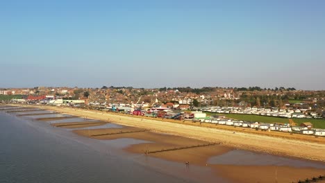 Aerial-view-of-Hunstanton-sea-front,-beach-and-water-breaks