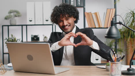 happy businessman making a heart shape with his hands