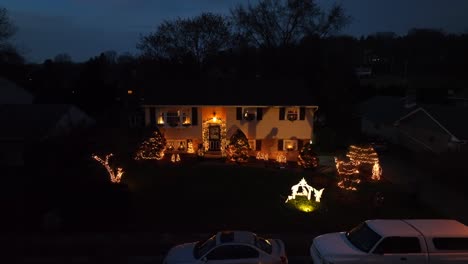 aerial shot of house with christmas lights at night