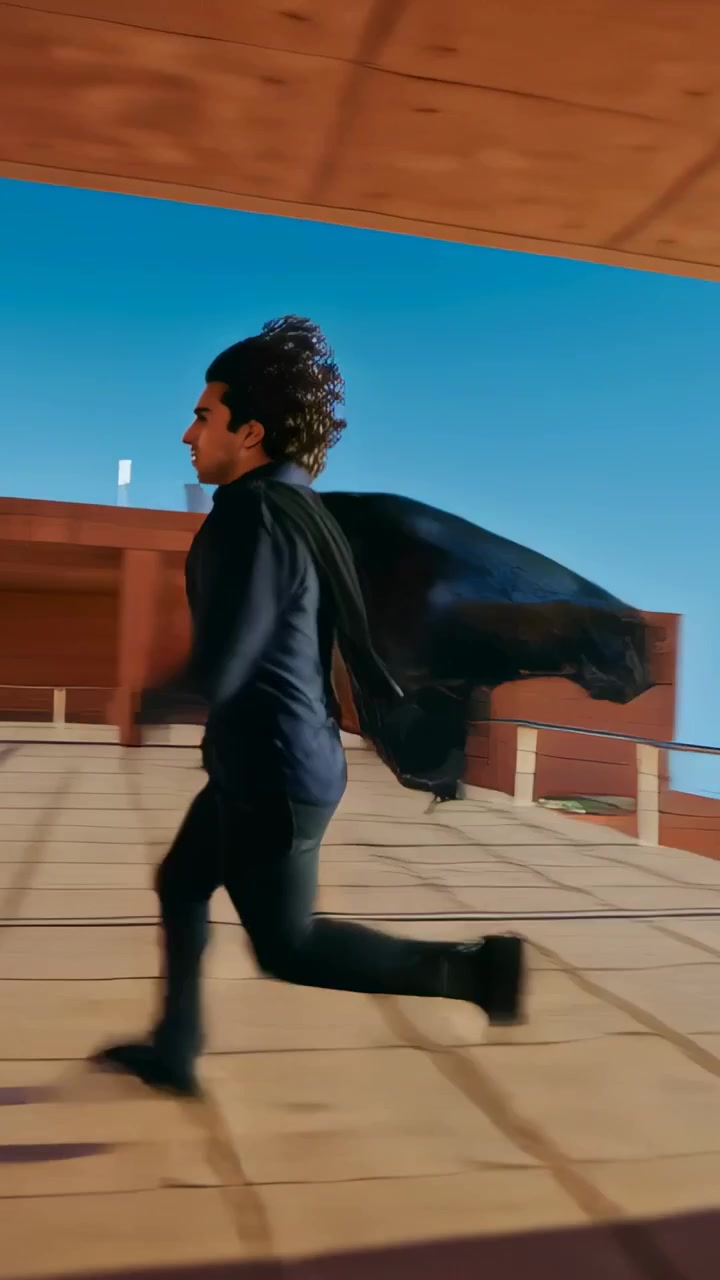 Vertical video: Opening black coat, man sprinting across roof, climbing block holding small item