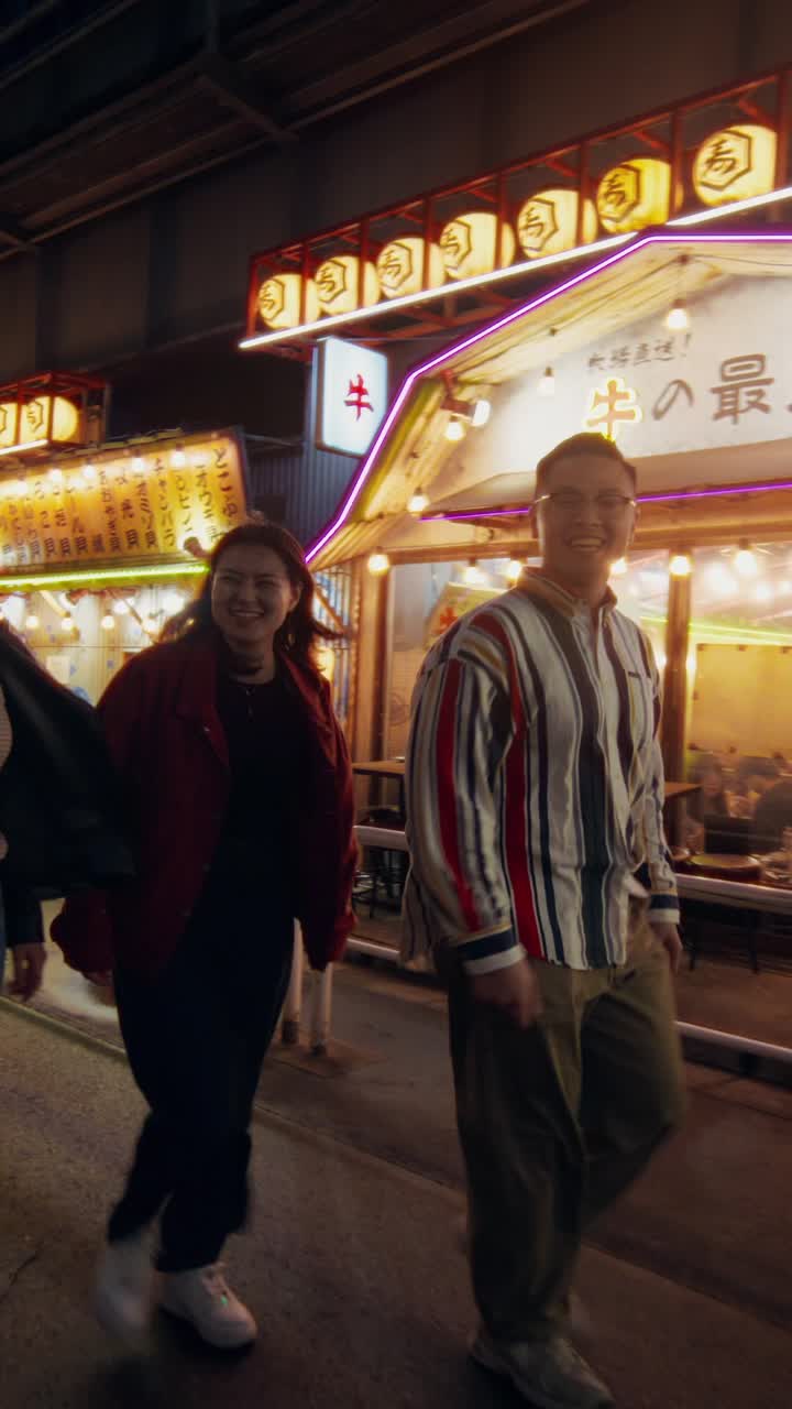 Group of friends enjoying a night out in a Japanese city