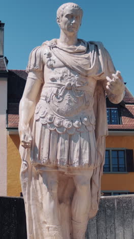 vertical: julius caesar statue outside roman museum during the day in nyon, canton of vaud, switzerland, medium shot