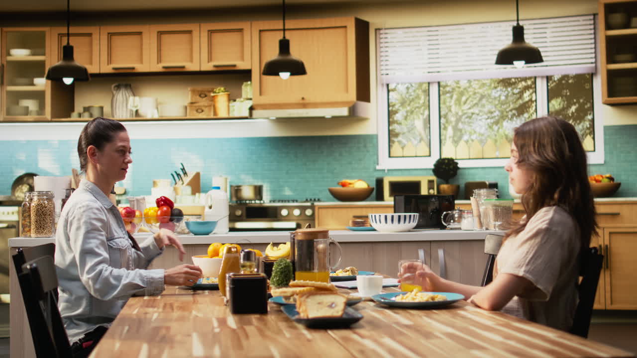 Distracted busy father studying some papers during breakfast meal